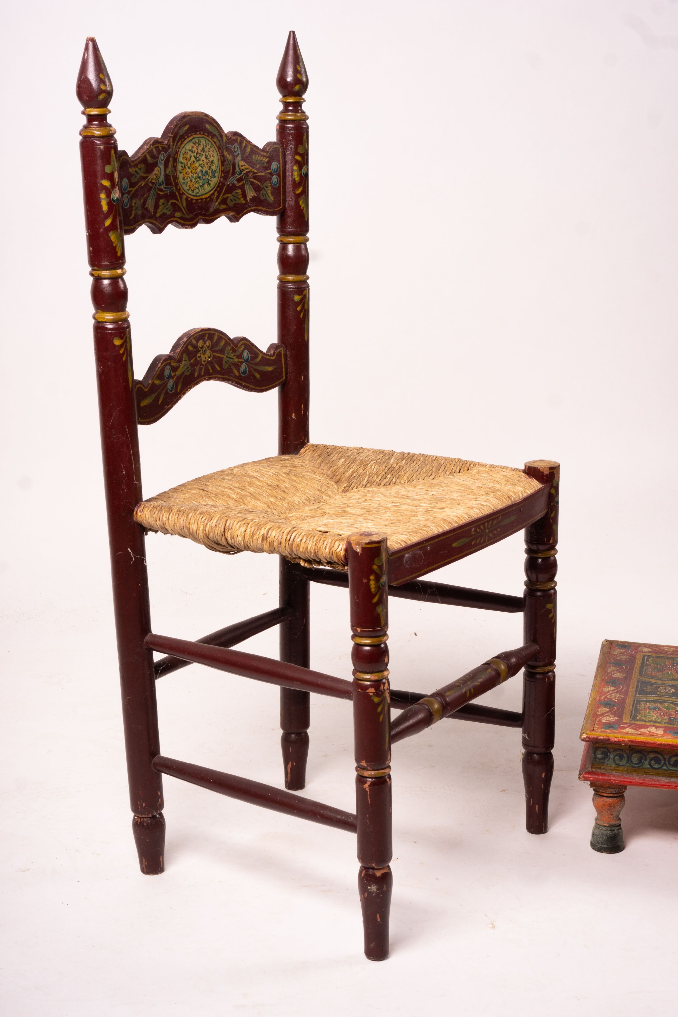 Two 19th / early 20th century Swiss painted rush seat chairs, together with a square low table